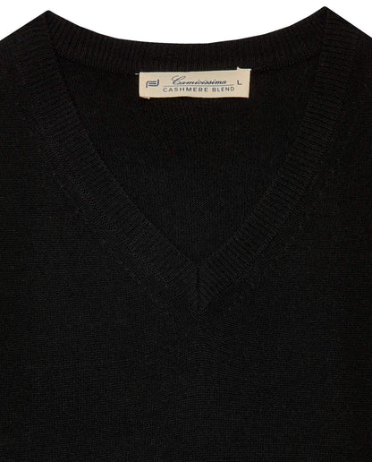 Black V-neck knit sweater close-up, neckline ribbing and care label