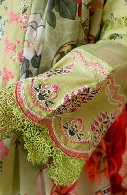 Close-up of parrot green fabric with floral embroidery and scalloped lace trim