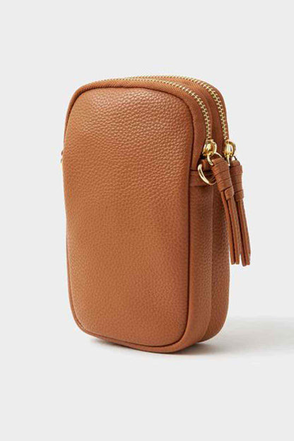 Accessorize tan mini crossbody bag side view with tassel detail and rounded shape