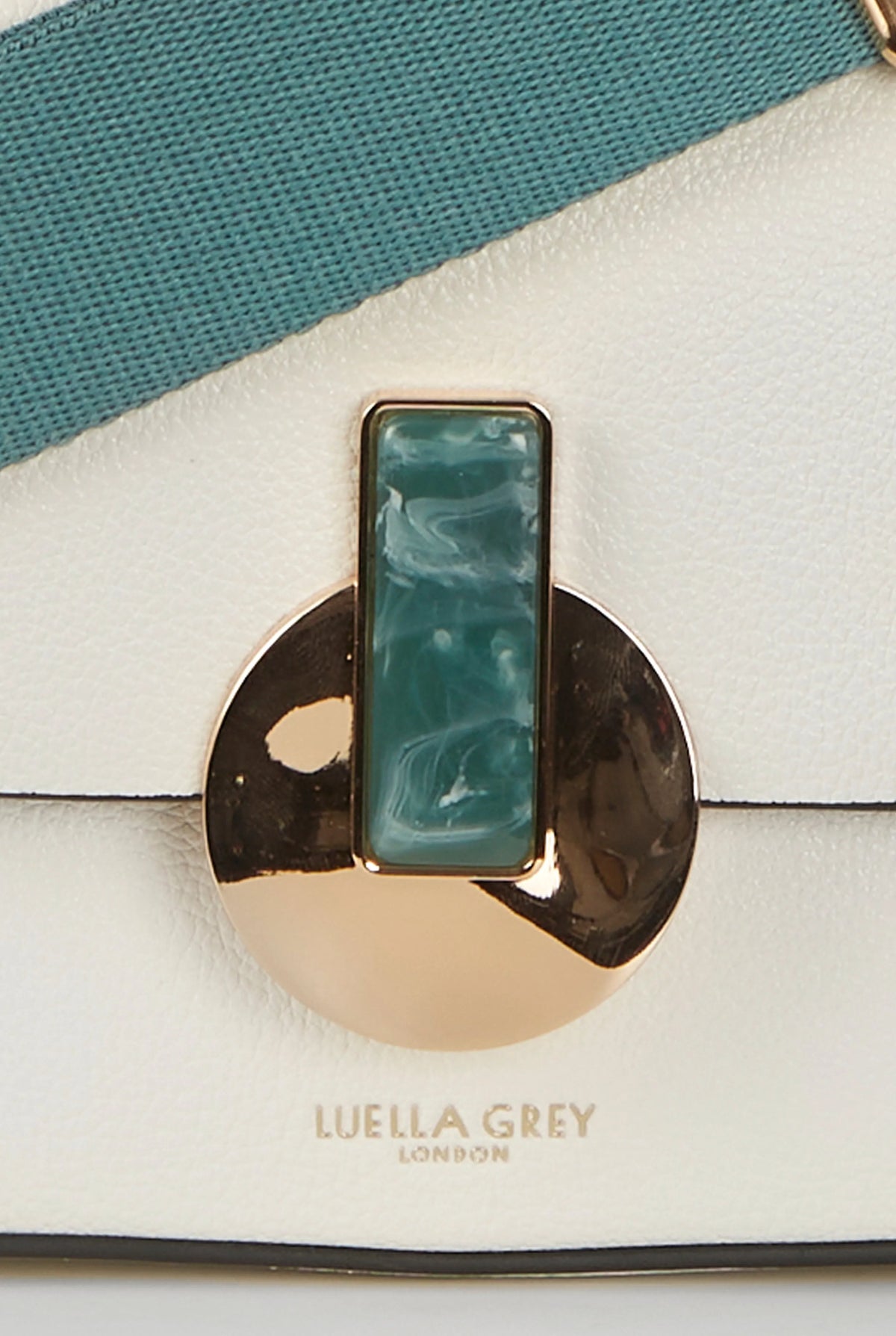Teal inset clasp on white flap handbag with gold-toned hardware and centered logo