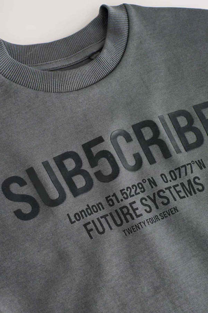 Kids dark grey T-shirt collar and 'SUBSCRIBE' graphic lettering close-up