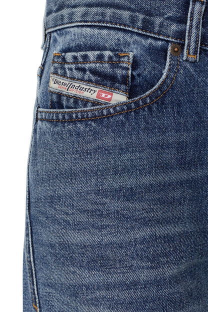 Diesel blue denim jeans close-up of front pocket and branded waistband patch