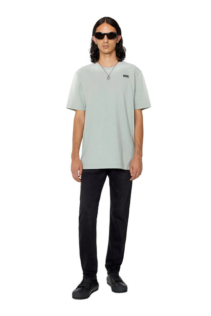 Black denim jeans on model with sneakers; straight fit, button fly