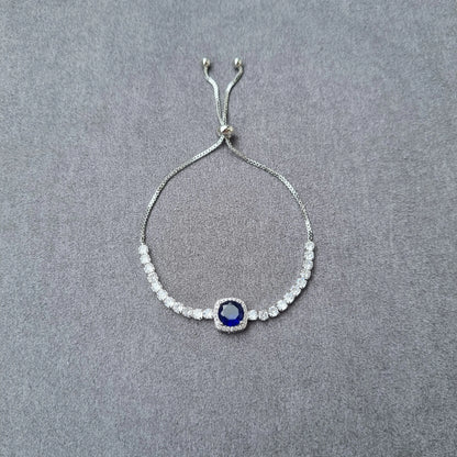Adjustable silver-tone beaded bracelet with round blue centerpiece and small crystals