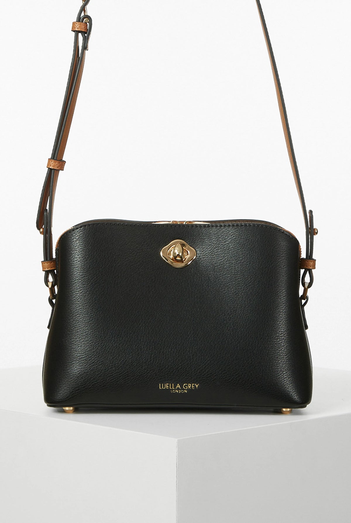 Black mini crossbody bag with gold twist-lock clasp and adjustable leather strap