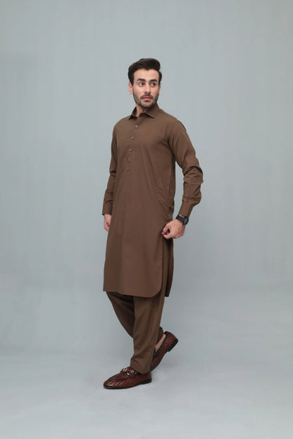 Men's brown shalwar suit with long kurta and tapered trousers, side view