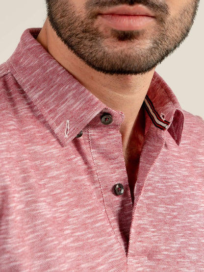 Pink polo shirt collar and button placket with striped trim on inner edge