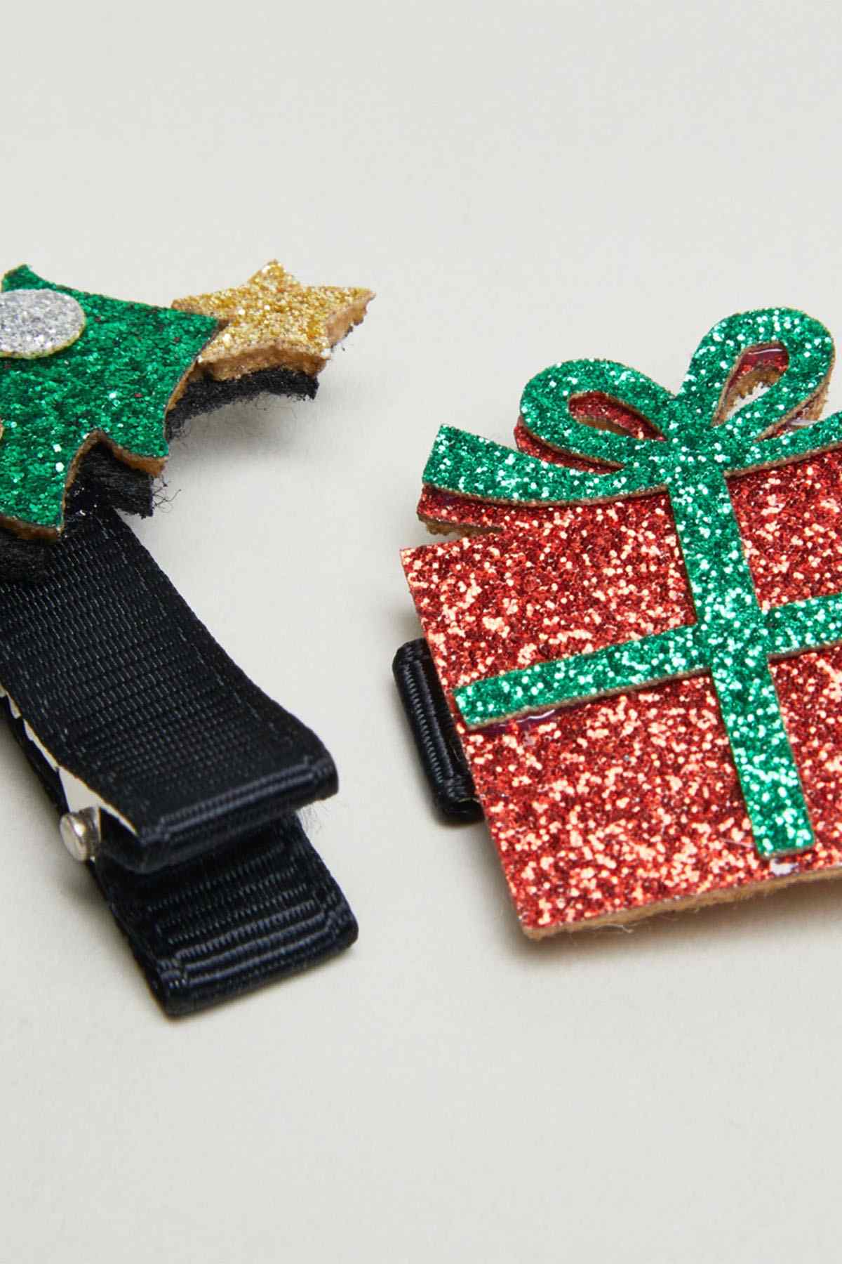 Glitter gift ribbon hair clips in red, green, and gold sparkles with dark blue clips