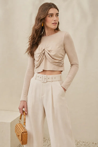 Beige ruched draped cropped top with long sleeves and high-waist wide-leg pants