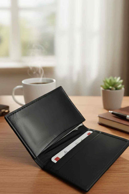 Black leather bifold wallet open, card slots visible inside