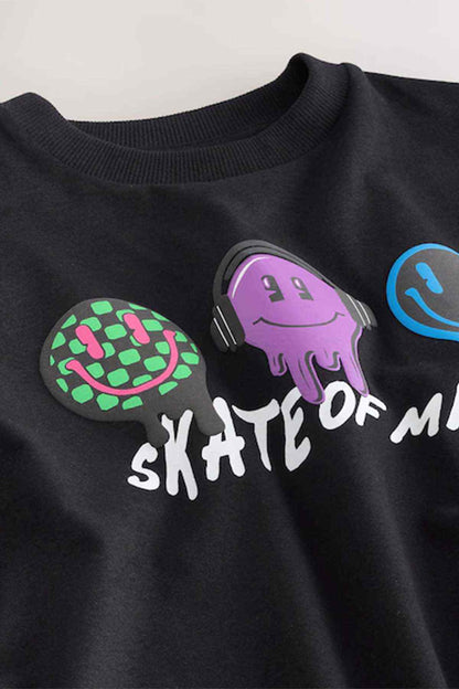 Black graphic T-shirt close-up with purple headphones, skate text and icons
