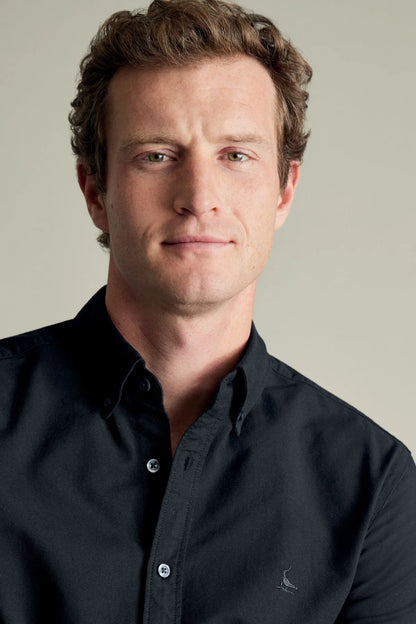 Black long-sleeve button-up shirt with collar and small chest logo