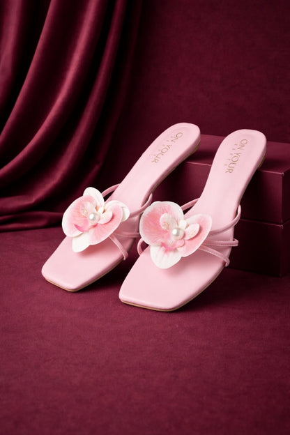 Light pink mule sandals with flower appliques and pearl centers on front straps