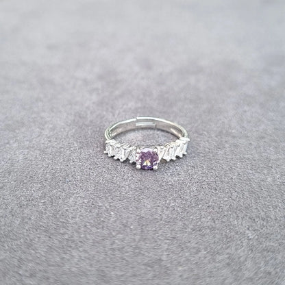 Silver-tone ring with purple square center gemstone and white fringe detailing