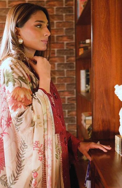 Maroon kurta set with floral cream dupatta, pearl necklace and side profile