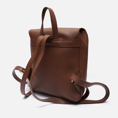 Brown leather mini backpack with top handle and shoulder straps; side loop and pocket strap.