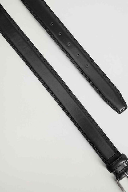 Black leather belt strap detail with stitched edge and punched adjustment holes
