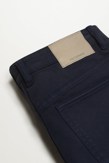 Dark navy jeans with stitched hem and tan brand patch