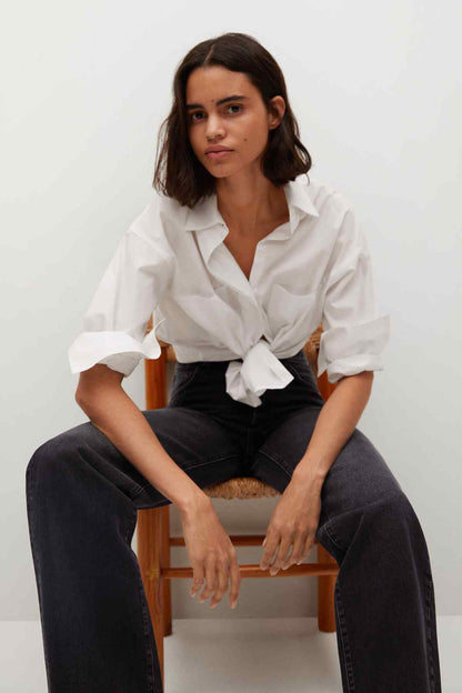 Black denim wide-leg jeans with front pockets and button fly