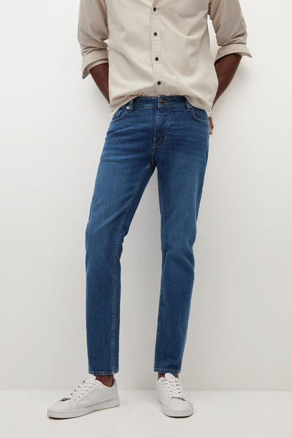 Dark blue denim jeans close-up, straight leg with belt loops and pockets