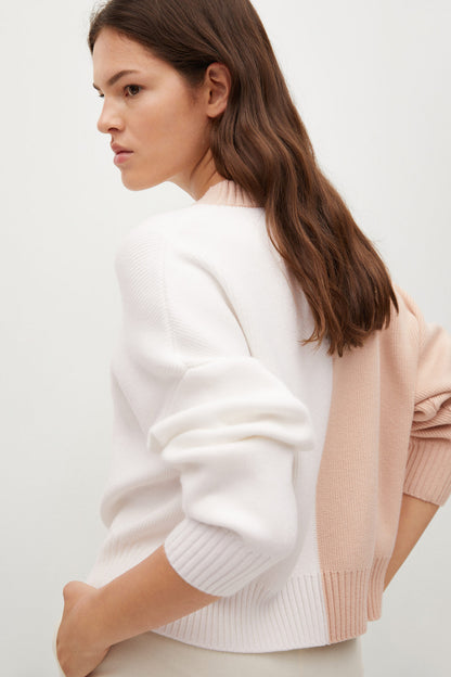 Light pastel grey knit sweater, crew neck and ribbed cuffs, side view
