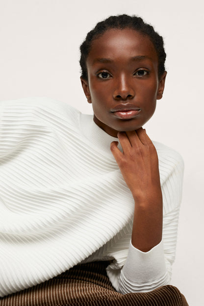 Off-white knit sweater close-up: ribbed crew neck, fine horizontal stripes