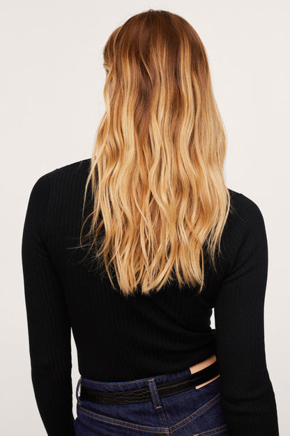 MANGO black fitted long-sleeve ribbed knit top, back view with dark jeans
