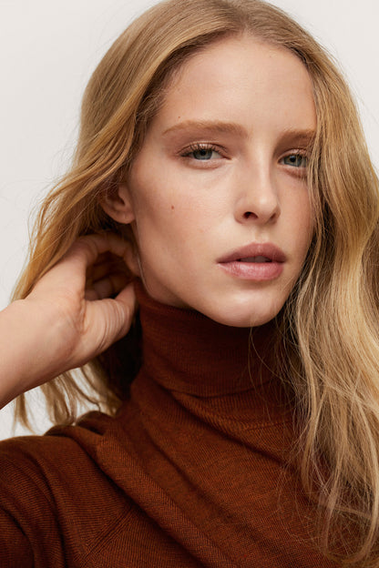 Russet knit turtleneck sweater with long sleeves, close-up on neckline