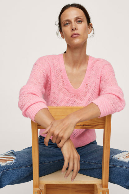 Pastel pink V-neck knit sweater with long sleeves and ribbed cuffs