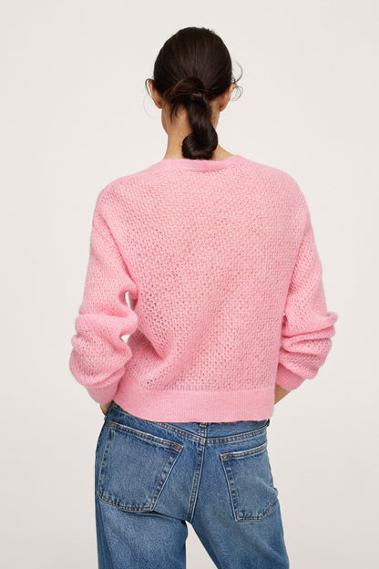 Pastel pink knit sweater back view with long sleeves and ribbed cuffs