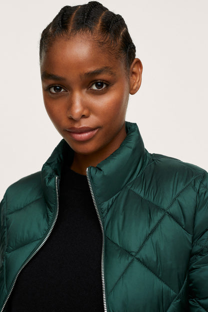 Dark green quilted puffer jacket close-up, zip front and high collar