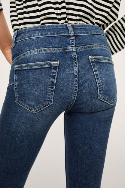Dark blue denim jeans close-up of waistband and back patch pockets