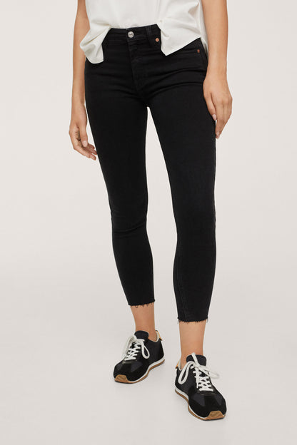 Black denim skinny cropped jeans with five-pocket styling and button closure