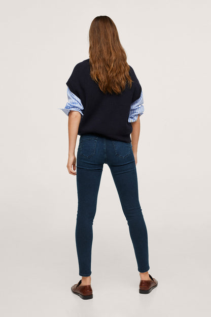 Navy sleeveless knit vest with crew neck, back view, over striped blue sleeves