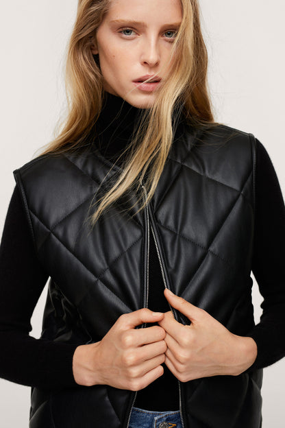 Black quilted zip-front jacket with stand collar and exposed zipper