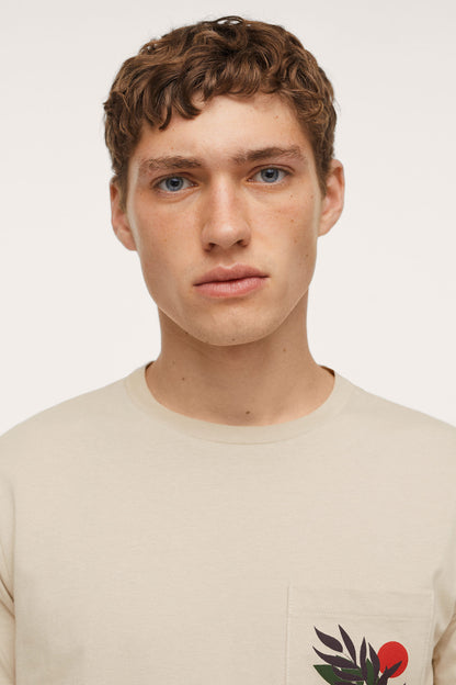 Beige crew-neck T-shirt close-up of chest leaf and red berry graphic