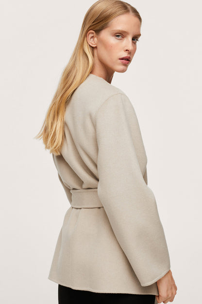 Ecru belted jacket, side view with cuffed sleeve and waist tie