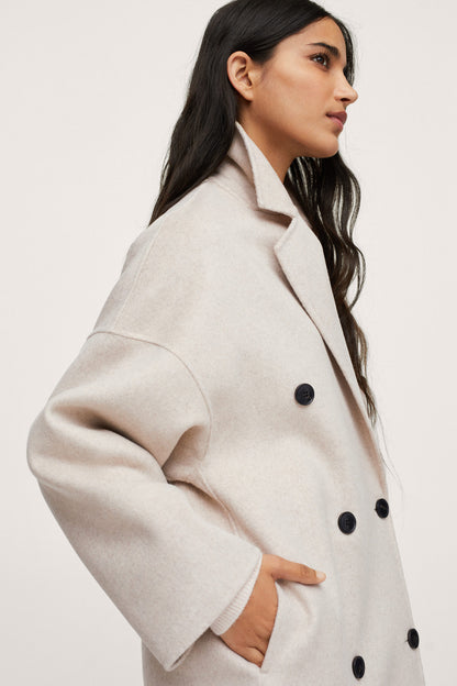 Light pastel gray double-breasted overcoat with notch lapels and dark buttons