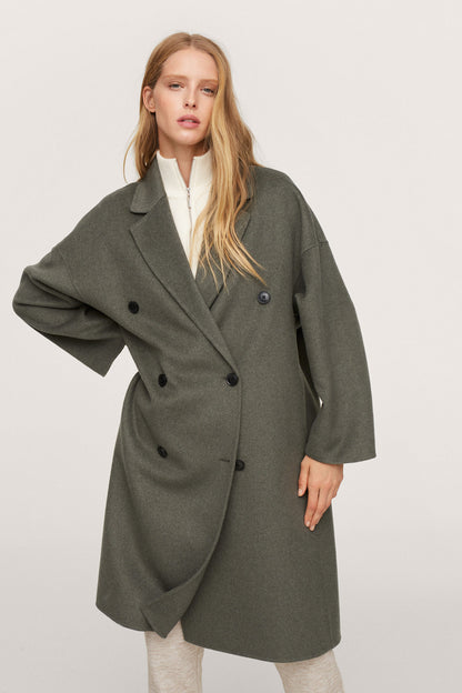 Dark green double-breasted long coat with notched lapels and large button front
