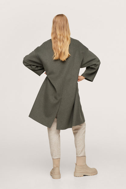 Dark green double-breasted long coat, back view with flap pockets