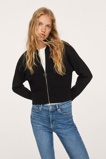 Black zip hoodie with gold zipper detail, worn with medium-blue mid-rise jeans