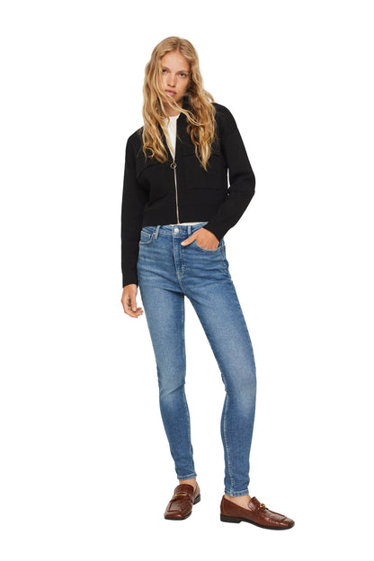 Black zip-up hoodie with hood, front pockets, worn with medium-blue skinny jeans