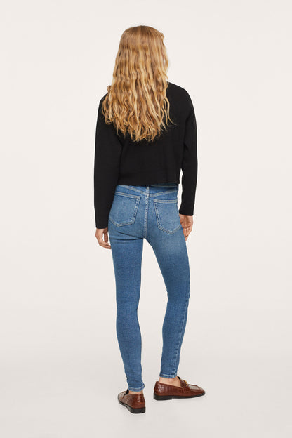 Black hoodie, back view, paired with medium-blue skinny jeans