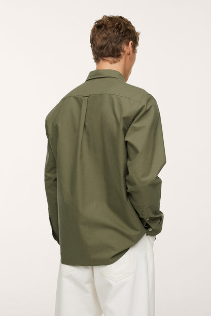 Men's khaki button-up shirt, rear view with back yoke and button cuffs