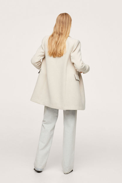 Light grey blazer back view with shoulder seams and slightly flared hem