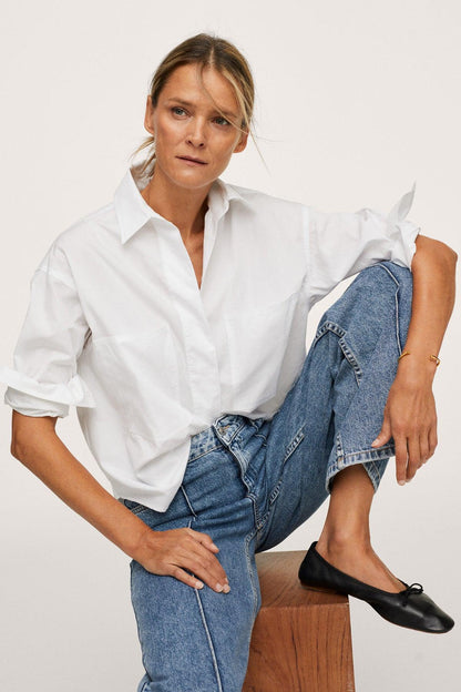 Medium-blue denim jeans with button fly, straight legs, and contrast seam stitching