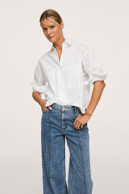 Medium-blue denim jeans with straight leg, front seam stitching, and belt loops