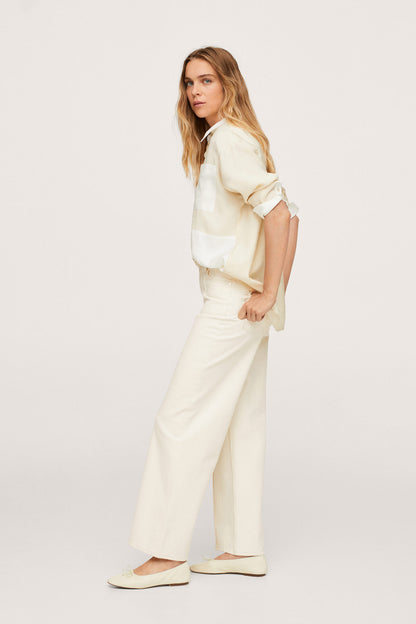Ecru button-up shirt and wide-leg trousers set, side view with rolled sleeves