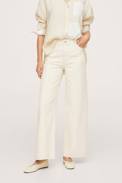 Ecru wide-leg trousers and button-up shirt, standing view showing pant length