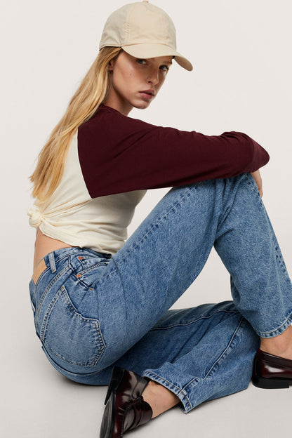 Medium-blue denim jeans with stitched seams, belt loops, and relaxed straight legs